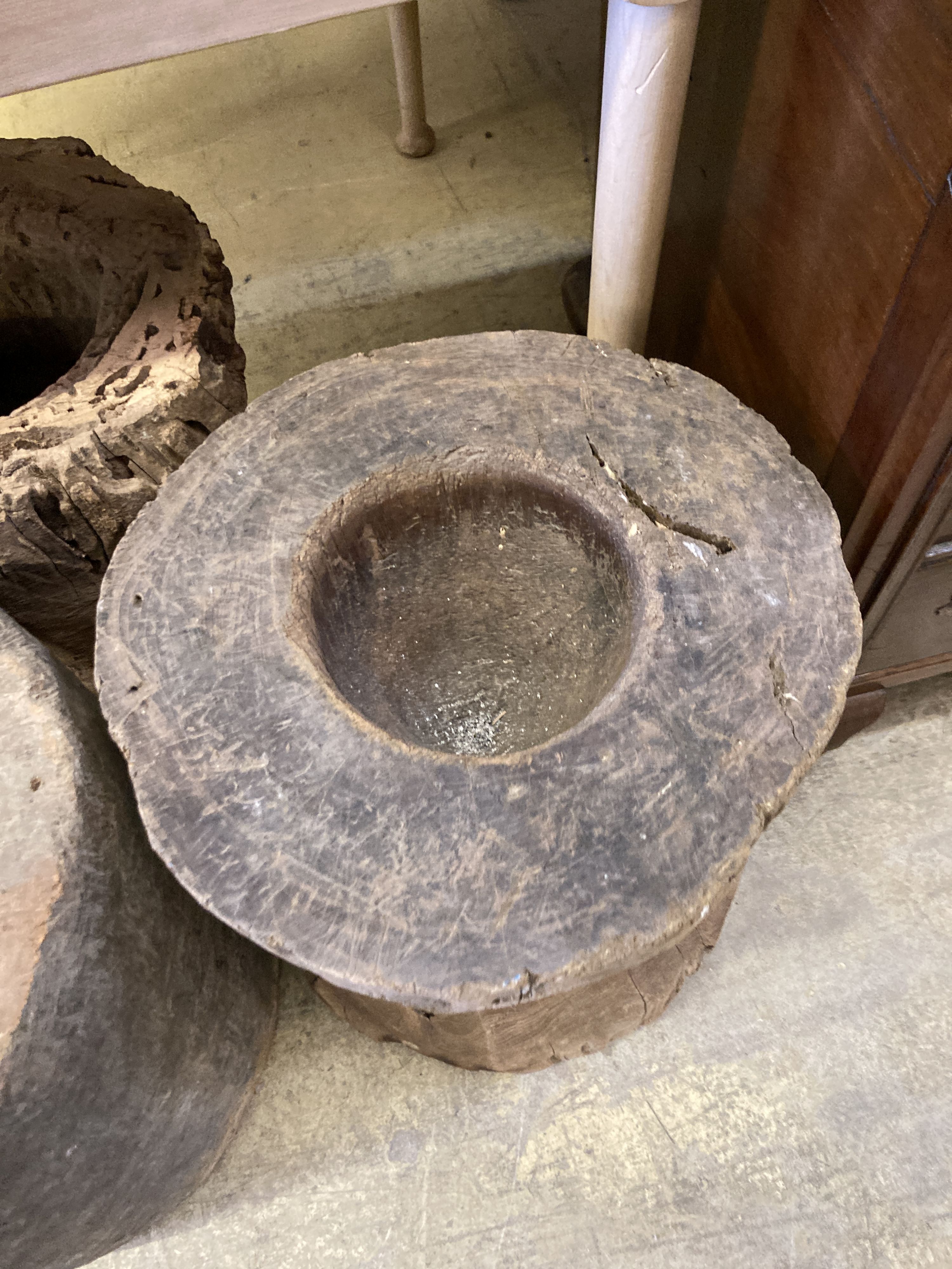 Three Indonesian hardwood rice mortars, largest 46cm high